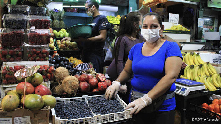 vendor wears a protective mask