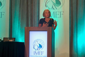 Cordia Harrington of Crown Bakeries speaks at IMEF Breakfast at 125th IAOM Conference and Expo